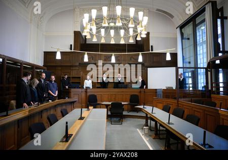 16 October 2024, Berlin: Arne Semsrott (4th from left), editor-in-chief of the internet portal "FragdenStaat", stands with his lawyers Benjamin Lück (l-r), Hannah Vos and Lukas Theune in the courtroom at Berlin District Court at the start of a trial against him. In the center is presiding judge Bo Meyer. The prosecution accuses the journalist of publishing court orders without permission. In August 2023, the journalist allegedly published search warrants from an ongoing investigation against the climate group Letzte Generation, some of which were blacked out, in an article. Photo: Bernd von Ju Stock Photo