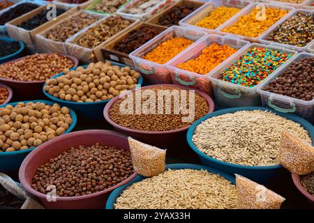 Diverse array of spices and nuts is displayed in vibrant bowls at a lively market in Turkey inviting shoppers to explore local tastes and aromas. Stock Photo