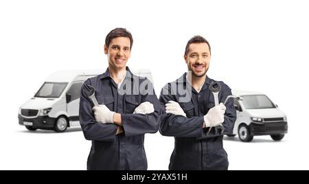 Two male workers with vans holding tools isolated on white background Stock Photo