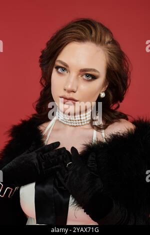 A young beautiful woman exudes sophistication in her elegant outfit and glamorous accessories. Stock Photo