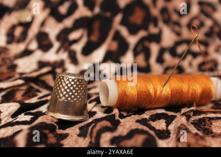 Spool of Tan Thread on Vintage Leopard Print Fabric Stock Photo - Alamy
