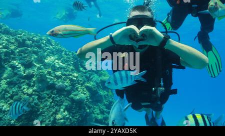 Scuba diver making heart with his hands Stock Photo