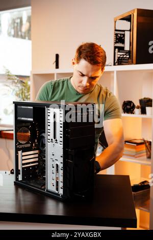 Man assembles a computer system unit at home Stock Photo