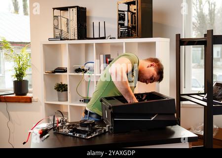 Man assembles a computer system unit at home Stock Photo
