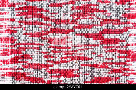 Old handmade homespun doormat from strips of cloth. Texture of a homemade rug from different fabrics Stock Photo