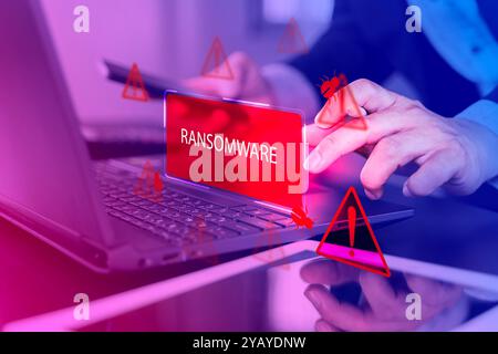 Malware attack virus alert. Person use laptop with virtual warning sign with ransomware word, warning notification. Cyber threats.Cyberattack cybercri Stock Photo