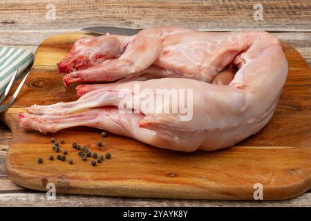 whole rabbit, ready to cook, on a cutting board Stock Photo