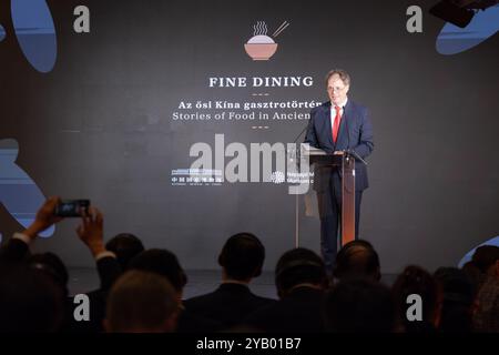 (241016) -- BUDAPEST, Oct. 16, 2024 (Xinhua) -- Deputy Secretary of State Gabor Csaba, representing Hungary's Ministry of Culture and Innovation, speaks during the opening ceremony of the 'Fine Dining: Food Stories of Ancient China' exhibition in Budapest, Hungary on Oct. 15, 2024. The Hungarian Museum of Ethnography in Budapest opened the highly anticipated exhibition 'Fine Dining: Food Stories of Ancient China' on Tuesday, offering visitors a fascinating journey through China's ancient culinary traditions. The exhibition, co-hosted with the National Museum of China, runs until Jan. 19, 202 Stock Photo