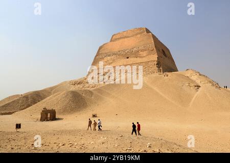 Beni Suef, Egypt. 16th Oct, 2024. Tourists accompanied by staff members visit the Meidum Pyramid in Beni Suef Governorate, Egypt, Oct. 16, 2024. Meidum Pyramid is thought to be built by Pharaoh Sneferu, the first pharaoh of the Fourth Dynasty of ancient Egypt. The pyramid has a history of around 4,600 years. Credit: Sui Xiankai/Xinhua/Alamy Live News Stock Photo