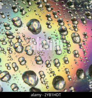 Close up of droplets and water drops on the surface of colorful CD Stock Photo