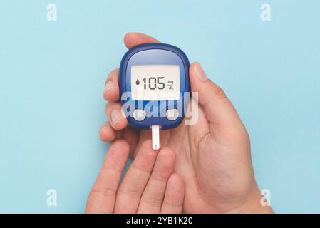 Person checking blood sugar level with glucometer. Diabetes concept Stock Photo