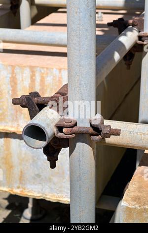 Close up view of the metal connection brackets and bolts on scaffolding Stock Photo
