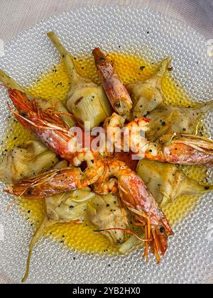 Grilled prawns with artichokes and olive oil. Spain. Stock Photo