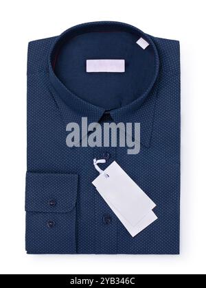 Dark blue long sleeve folded dress shirt with a small white dot pattern on the fabric, isolated on a white background, top view Stock Photo