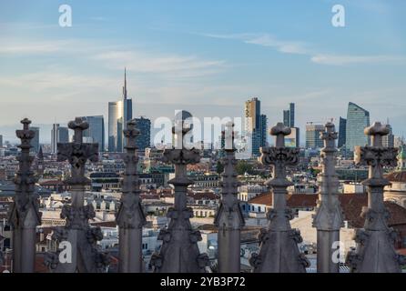 A picture of the Duomo di Milano or Milan Cathedral roof spires and statues overlooking the Porta Nuova business district. Stock Photo