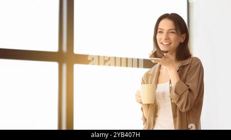 Young woman using mobile voice recognition function Stock Photo
