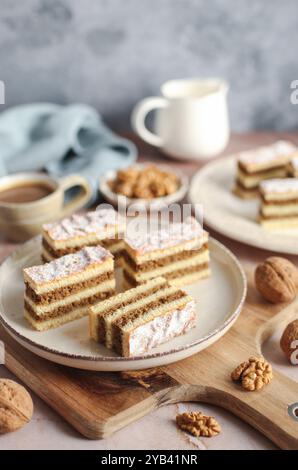 Traditional walnut pie on a plate. Cup of coffee and blue napkin in the background. Stock Photo