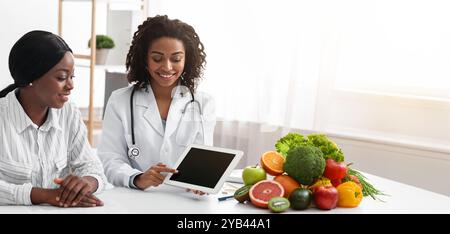 Dietologist using digital tablet in office, making patient's anamnesis Stock Photo