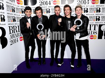 File photo dated 19/02/14 of (left to right) Zayn Malik, Harry Styles, Liam Payne, Louis Tomlinson and Nial Horan from One Direction with their Awards in the press room at the 2014 Brit Awards at the O2 Arena, London.. Liam Payne has died after falling from the third floor of a hotel in Buenos Aires, according to local officials. He was 31. Issue date: Wednesday October 16, 2024. Stock Photo