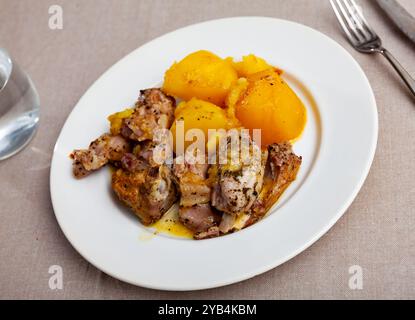 Braised rabbit served with potato garnish Stock Photo