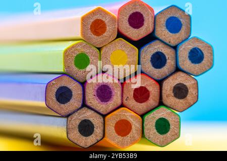 This image shows a close-up view of the back ends of a bundle of colored pencils arranged in a row. Stock Photo