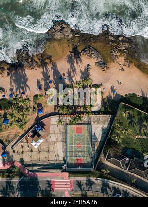 Salvador, Brazil - beachside basketball and football courts with a Birds Eye view, palm tree shadows reflecting on the white sand Stock Photo