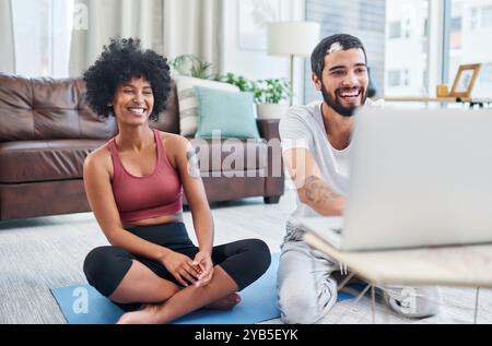 Laptop, start and yoga with couple in living room of home while happy of exercise or online class together. Computer, smile or streaming with yogi man Stock Photo