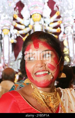 End of Durga Puja Festival Celebrations A Hindu woman is seen with her face smudges vermillion, a red powder, after worshipping an idol of the Hindu goddess Durga marking the last day of Durga Puja festival celebrations. on October 13, 2024 in Kolkata, India. Kolkata West Bengal India Copyright: xDipaxChakrabortyx Stock Photo