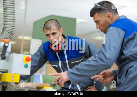 modern industrial machine operators working in factory Stock Photo