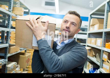 porter carrying boxes in a warehouse Stock Photo