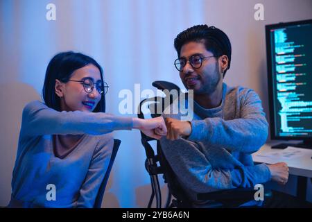 asian and Indian Developer team clapping hand for project success  with software computer at night in office Stock Photo