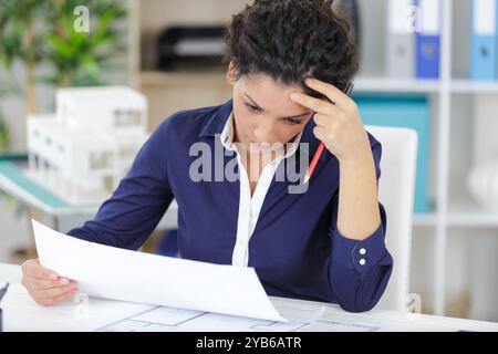 female construction engineer checking plans Stock Photo
