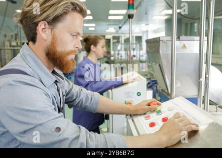 male engineer quality controlling components in factory Stock Photo