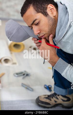 the builder thinking in work clothes Stock Photo