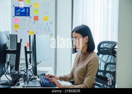 asian woman developer coding program ai in modern office Stock Photo