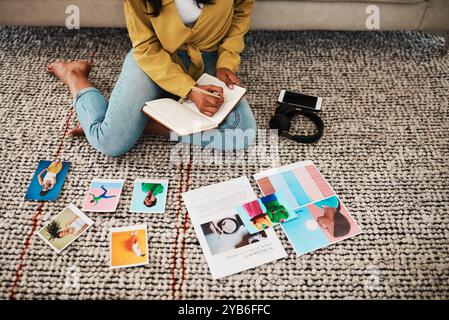 Pictures, creative and person with selection, working and writing of notes, home and photo editor on floor. House, planning and woman with ideas Stock Photo