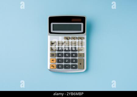 Top view of electronic calculator on blue background Stock Photo