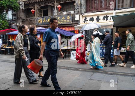 Xi'an, China - September 21 2024: Two woman wearing traditional chinese dress walk in the Shuyuanmen ancient cultural street in Xi'an old town near th Stock Photo