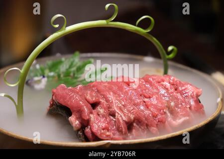 close up sliced raw beef meat in plate with dry ice. Stock Photo