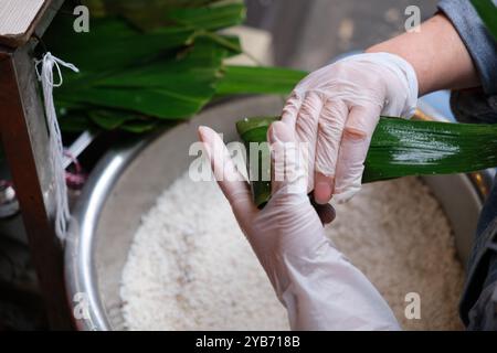 making Zongzi (rice dumpling or sticky rice dumpling). traditional Chinese food in Dragon Boat Festival Stock Photo