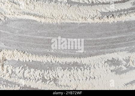 Grey cooking background of spilled wheat flour on stone background, top view. Stock Photo