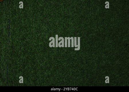 Artificial grass, covering. Artificial green grass mat, top view. Texture. Background. Artificial turf, surface made of synthetic fibers. Flat green g Stock Photo