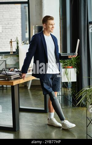 A determined young businessman confidently navigates his workspace while using an artificial limb. Stock Photo