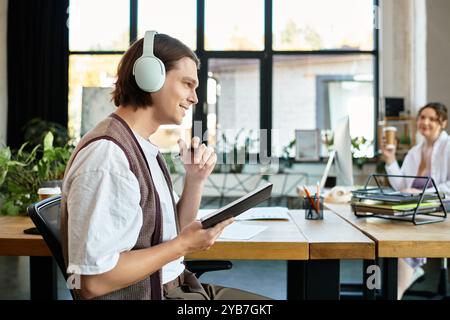 A cheerful young woman enjoys brainstorming with her attentive friend in an inviting office. Stock Photo