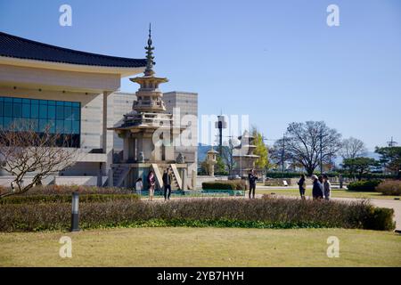 Gyeongju, South Korea - November 11th, 2023: Tourists explore the outdoor exhibits of Gyeongju National Museum, featuring intricately designed stone p Stock Photo