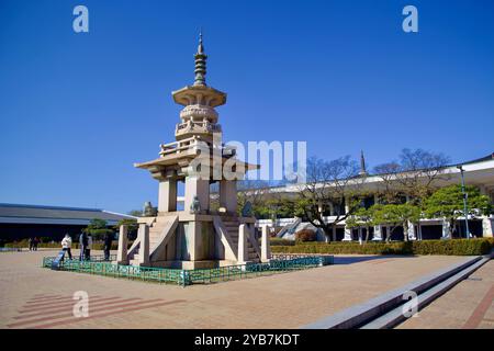 Gyeongju, South Korea - November 11th, 2023: A traditional stone pagoda stands prominently in the courtyard of Gyeongju National Museum, with visitors Stock Photo