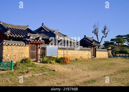 Gyeongju, South Korea - November 11th, 2023: Traditional Korean Munhosa Shrine with stone walls and tiled roofs, with Cheomseongdae visible in the dis Stock Photo