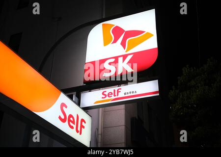 Jeju, South Korea-May 23rd 2024: SK Self gas station brand logo sign at night Stock Photo