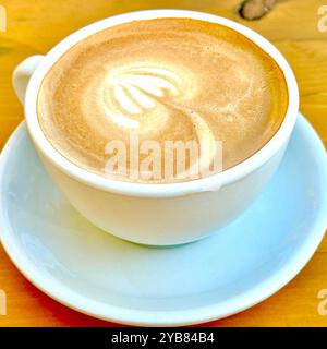 White cup with cortado coffee - on a wood table. No person Stock Photo
