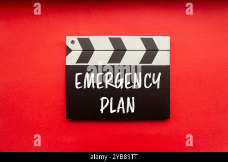 Emergency plan message written on clapperboard with red background. Conceptual emergency plan symbol. Copy space. Stock Photo